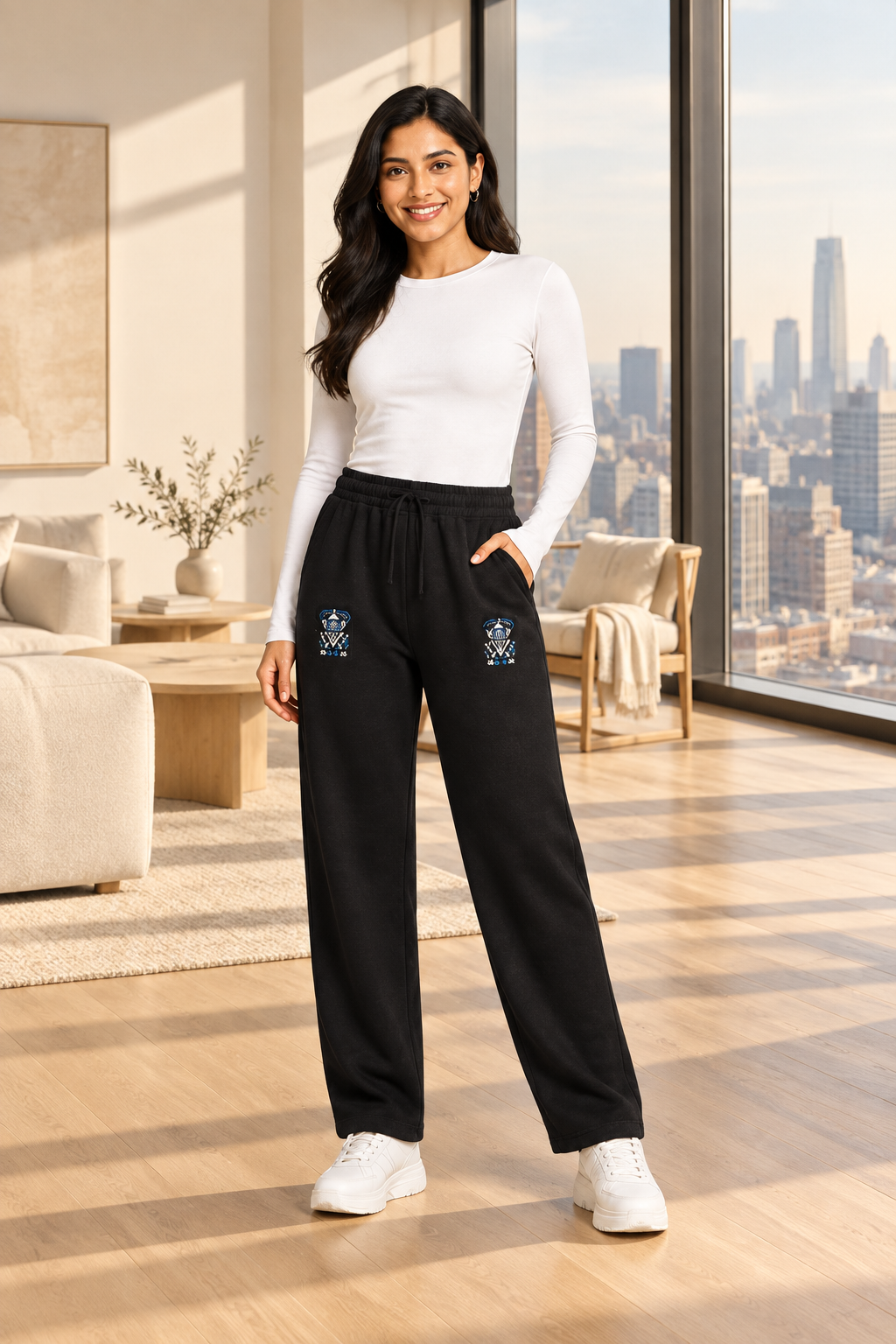 Woman wearing a white top and black pants on a white background